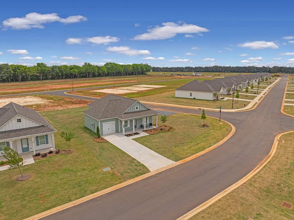 A residential area with houses and a curved road.