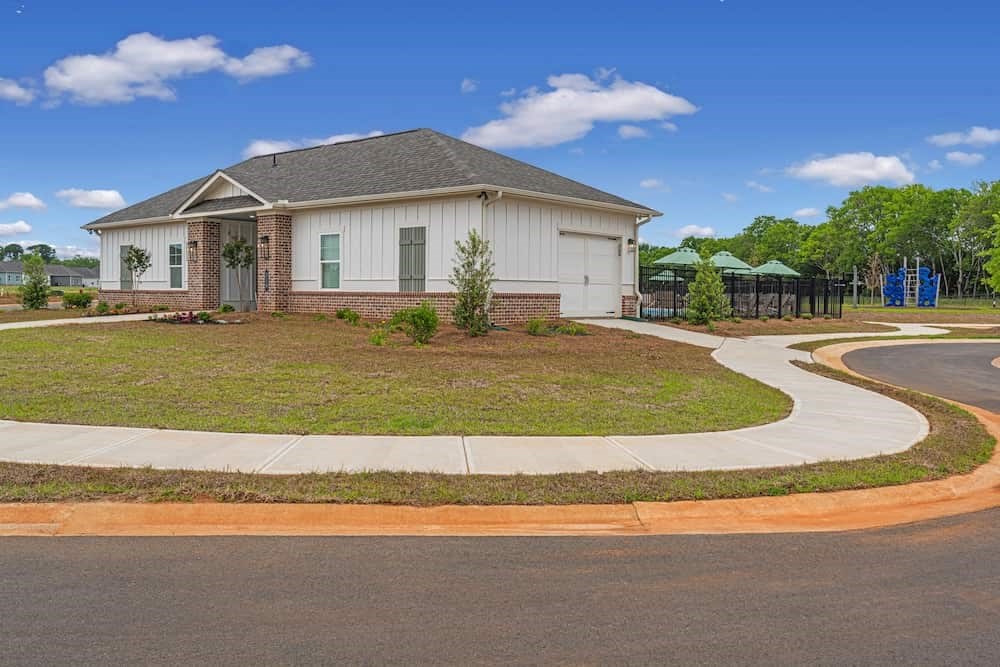 A house with a garage and a driveway in front of it.