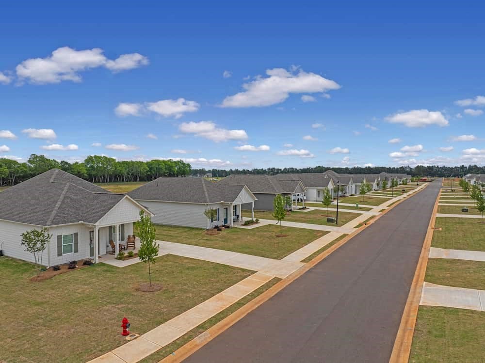 A row of houses with a red fire hydrant on the sidewalk.