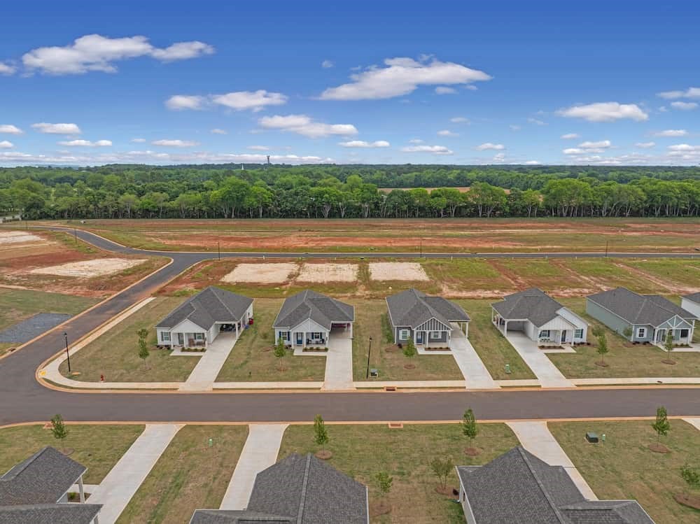 A suburban neighborhood with houses and a road.