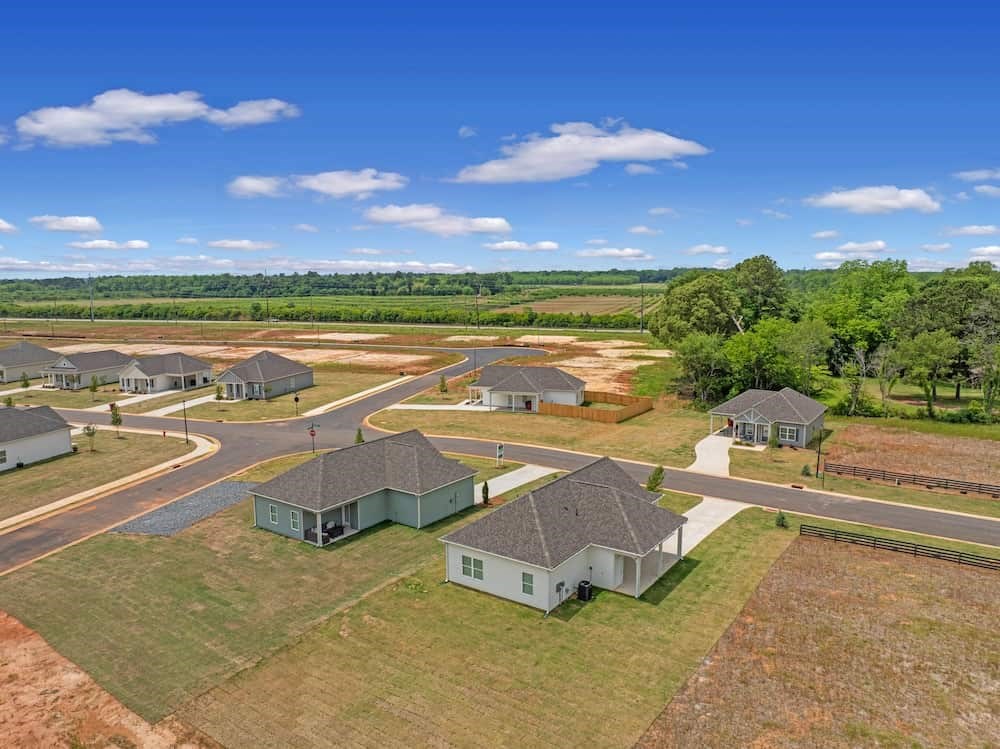 A bird's eye view of a residential area with houses and roads.