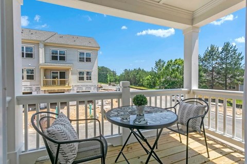 a patio with a table and chairs on a porch