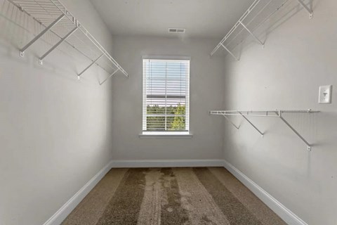 an empty room with white walls and a window