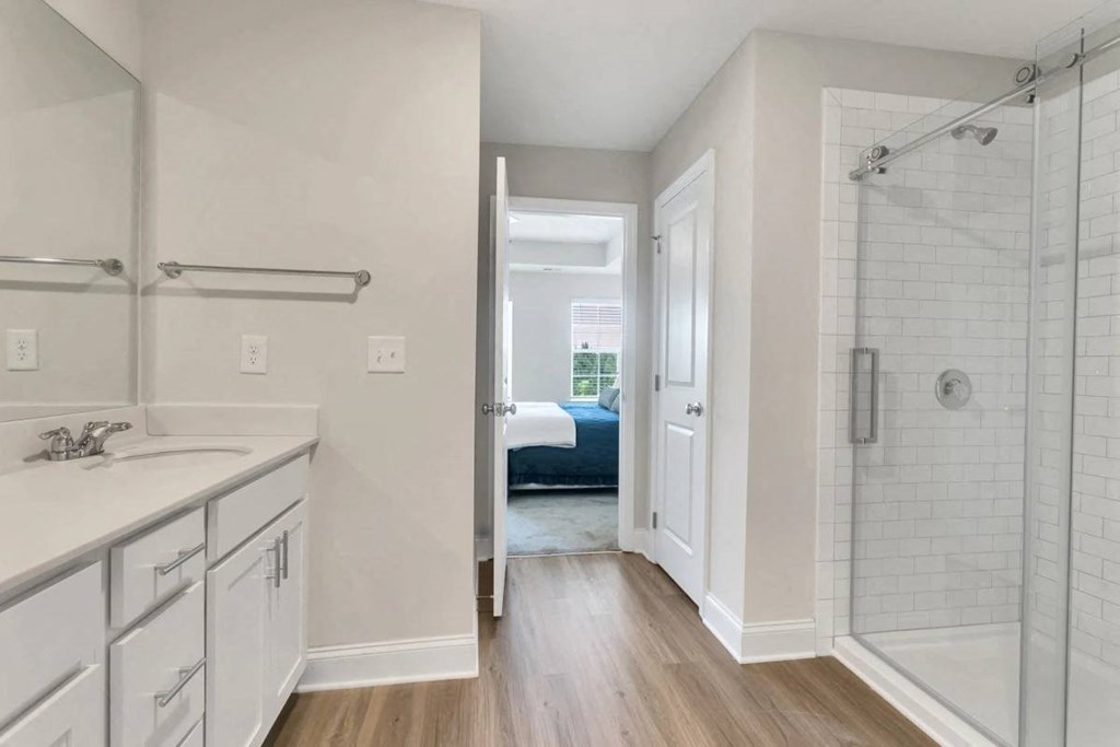 A white bathroom with a walk in shower.