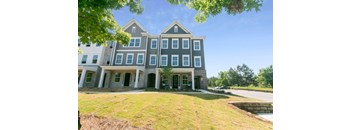 A large, two-story house with a grey and blue exterior.