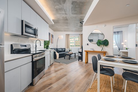 A modern kitchen with a dining table and chairs.