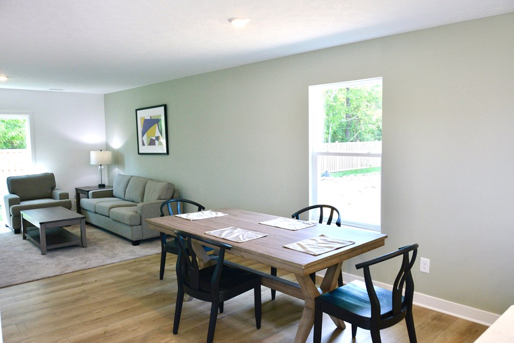 an open living room and dining room with a table and chairs