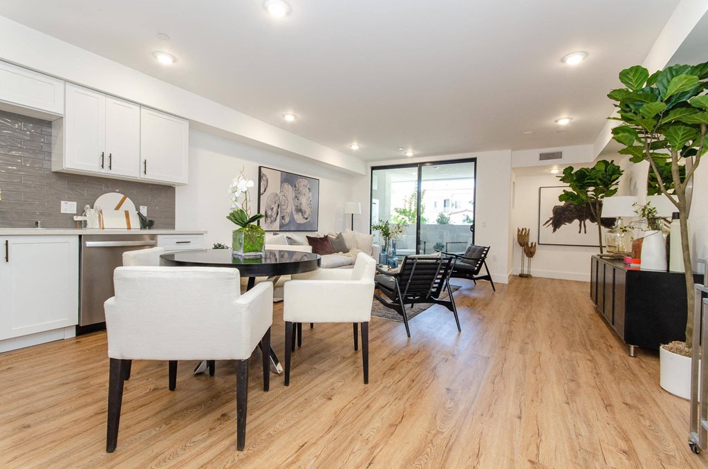 A modern kitchen with a dining table and chairs.