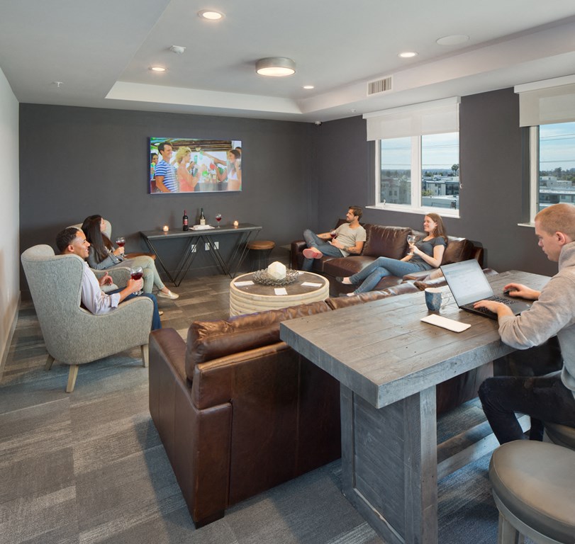 A group of people are sitting in a modern lounge area.