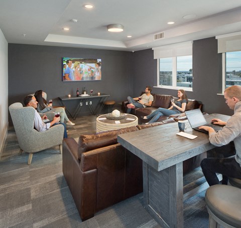 A group of people are sitting in a modern lounge area.