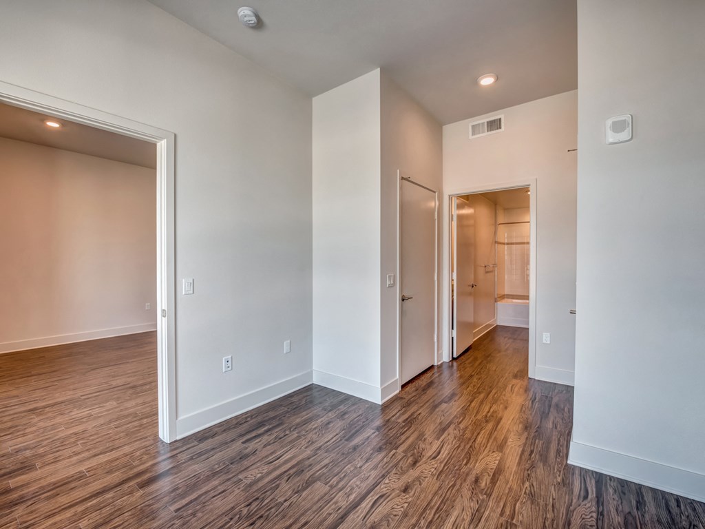 A room with wood flooring and white walls.