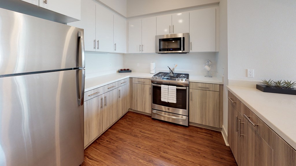 A modern kitchen with wooden cabinets and stainless steel appliances.