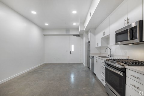 A kitchen with white cabinets and stainless steel appliances.