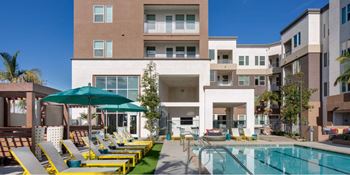 A large building with a pool in front of it.