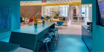 A brightly lit room with a bar and seating area.