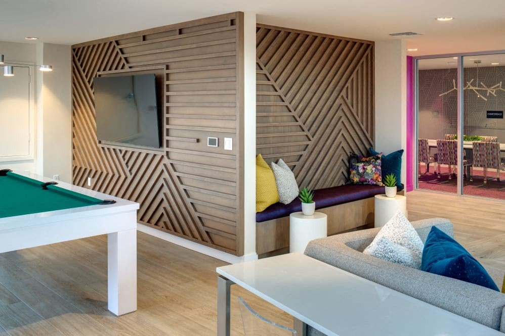 A room with a pool table and a couch.