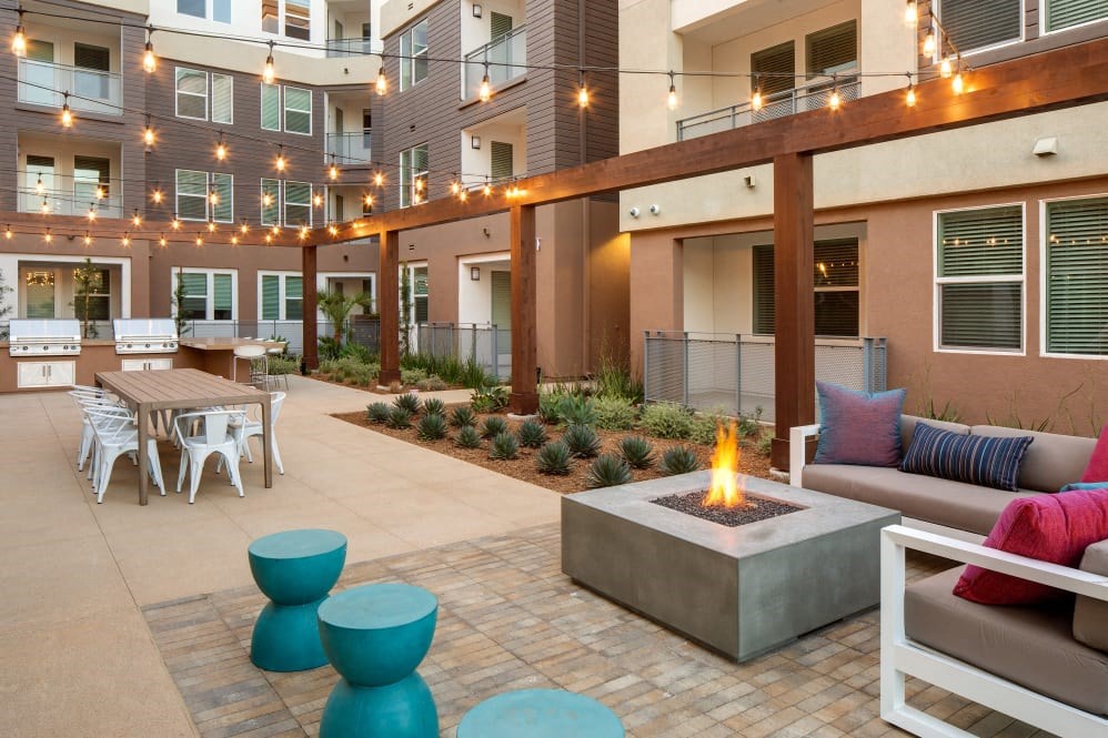 A patio with a fire pit and seating area.