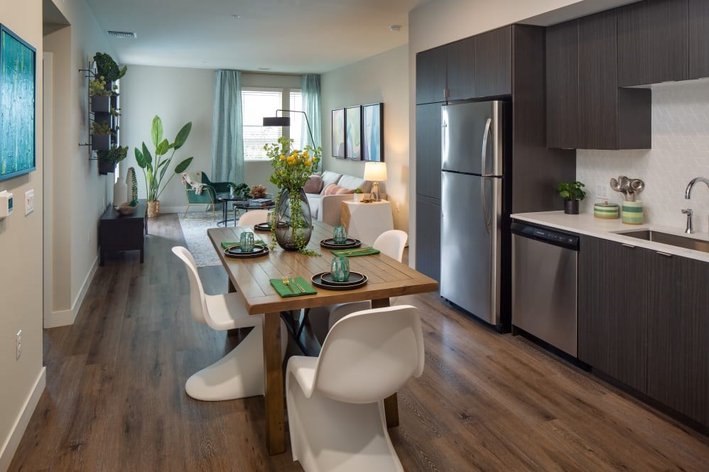 A modern kitchen with a dining table and chairs.