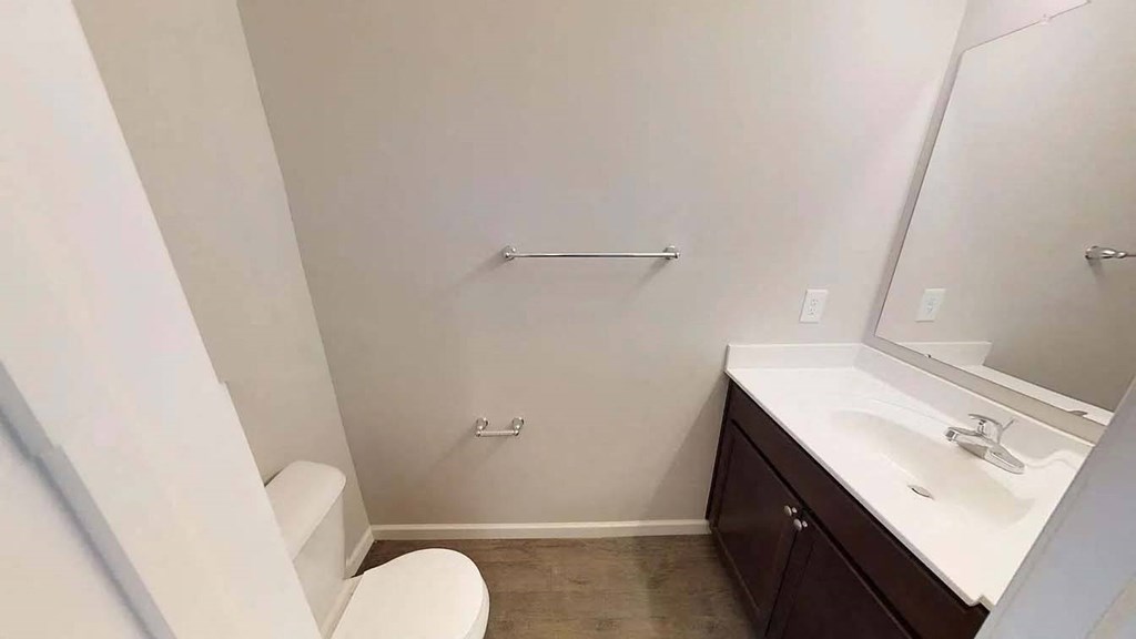 a bathroom with a toilet and a sink and a mirror