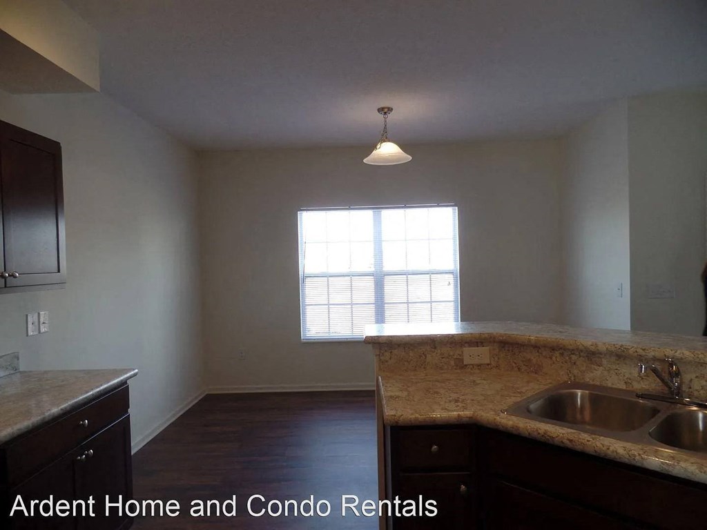 A kitchen with a sink and a window.
