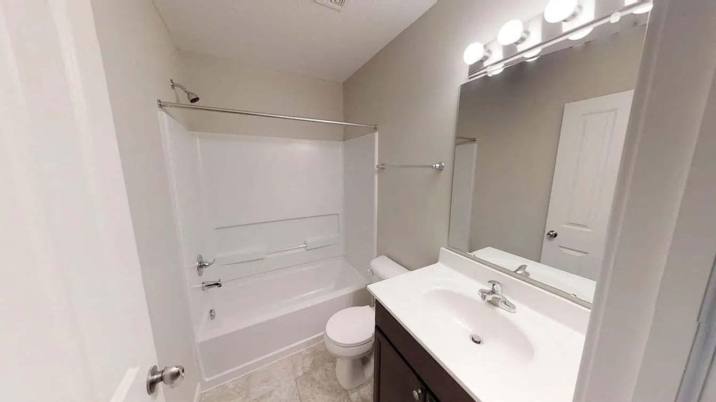 a bathroom with a sink and a toilet and a shower
