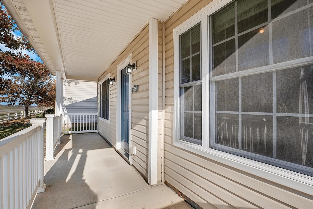 the front porch of a home with a blue door