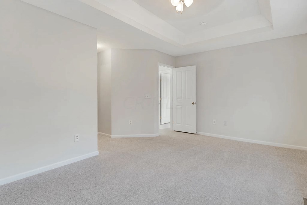 an empty living room with white walls and a white door