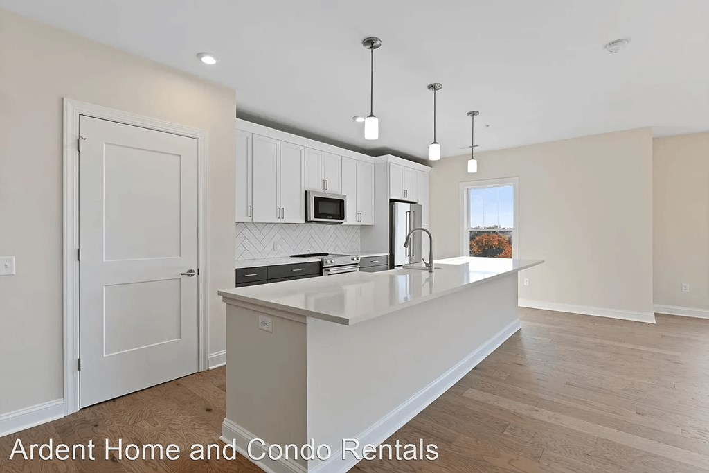 a kitchen with white cabinets and a white counter top