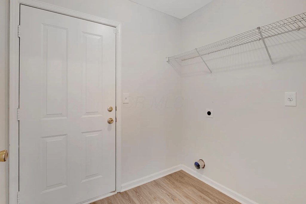 a bedroom with white walls and a closet with a white door
