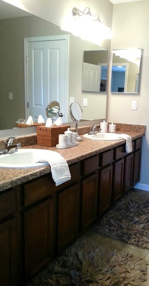 A bathroom with two sinks and a mirror.
