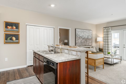 A kitchen with a sink and a counter.