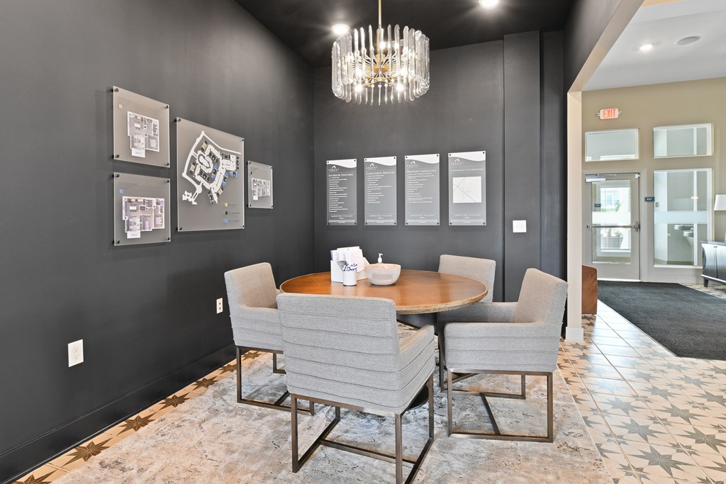 A dining room with a table and chairs.