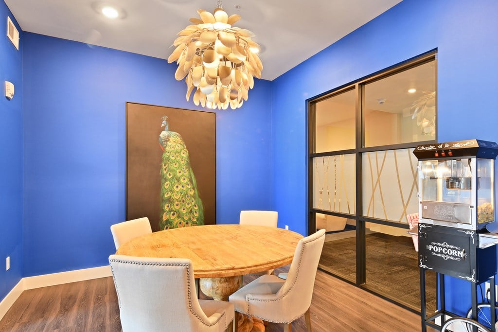 A dining room with a wooden table and chairs.