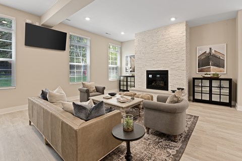 A modern living room with a large sectional sofa and a fireplace.