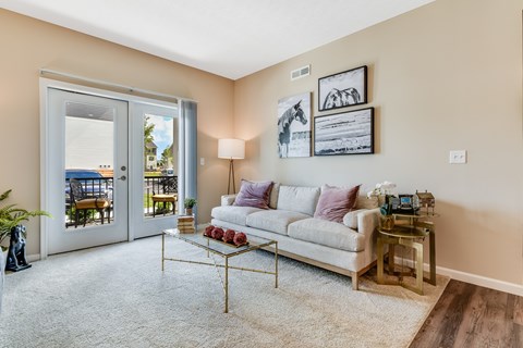 A living room with a white couch and a coffee table.