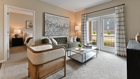 A living room with a couch, coffee table, and a large painting on the wall.