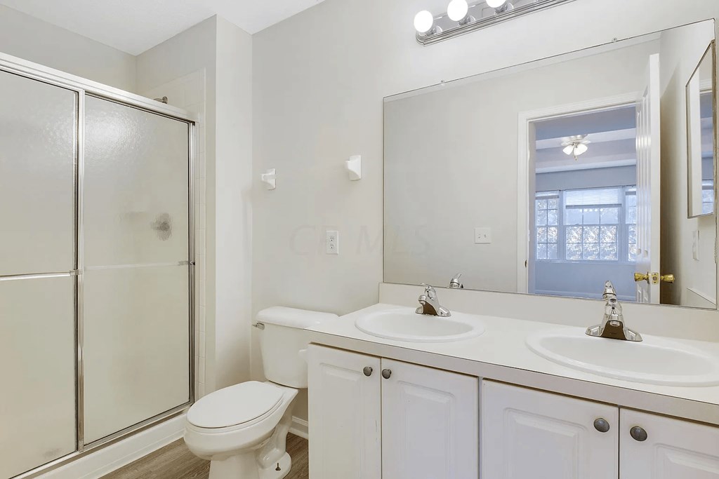 a bathroom with a toilet sink and a shower