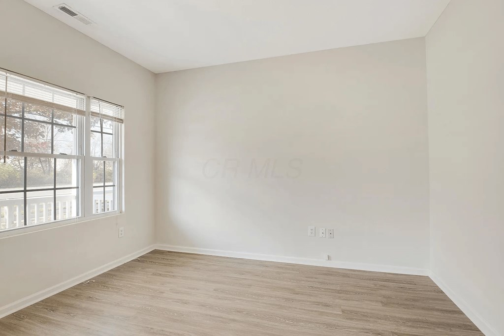 an empty room with white walls and a window