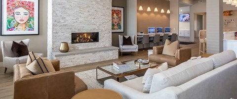 A living room with a fireplace and a painting on the wall.