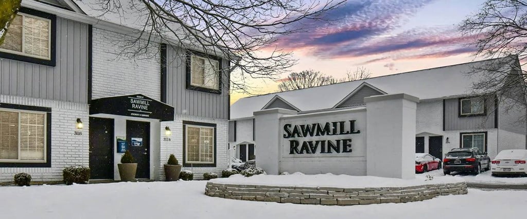 a building with a sign on it in the snow
