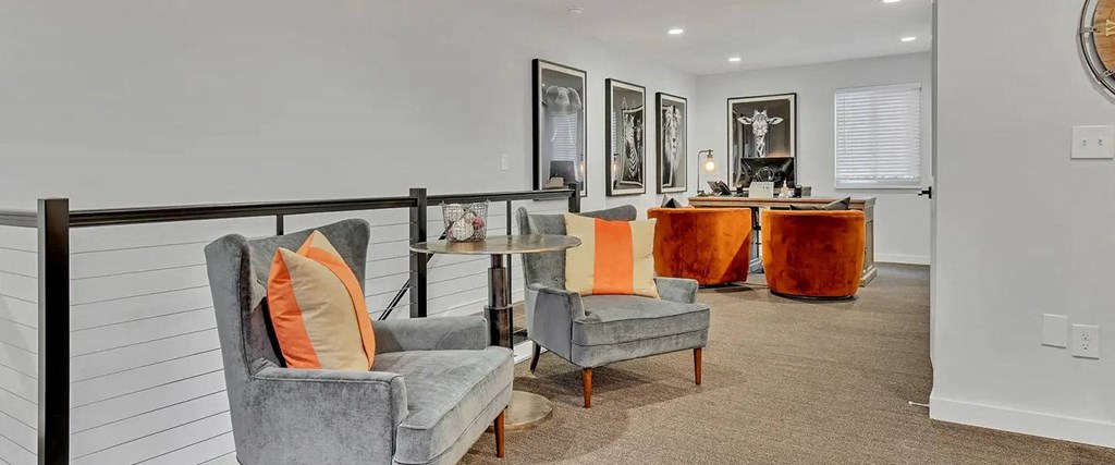 a living room with chairs and a bar