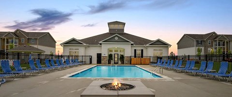 A pool with a fire pit in the middle of it.