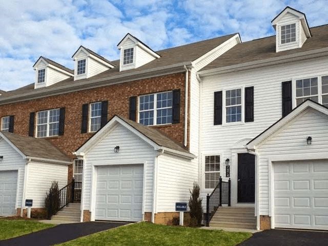 A row of houses with garages in front.