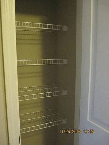 Empty shelves in a white refrigerator.