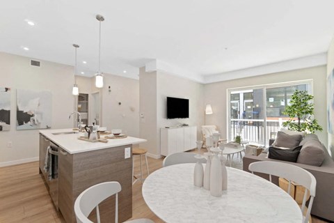 A modern kitchen with a dining table and chairs.