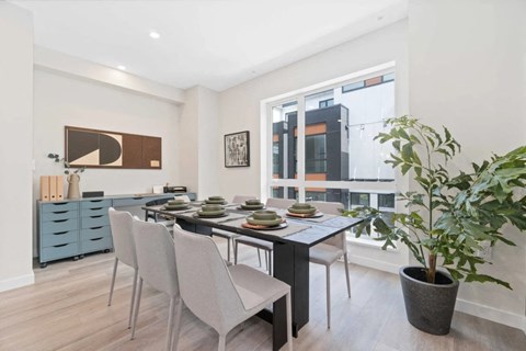 a dining room with a table and chairs and a large window