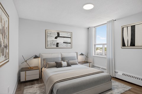 A bedroom with a large bed and a window.