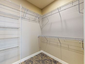 Empty walk-in closet with shelves and a carpeted floor.at Linc, Iowa   