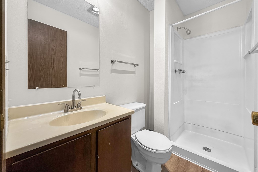 A white sink with a silver faucet is on a countertop.