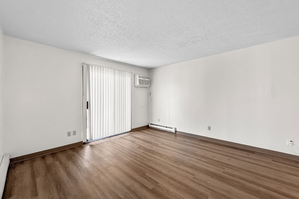 A room with wooden floors and a white door.